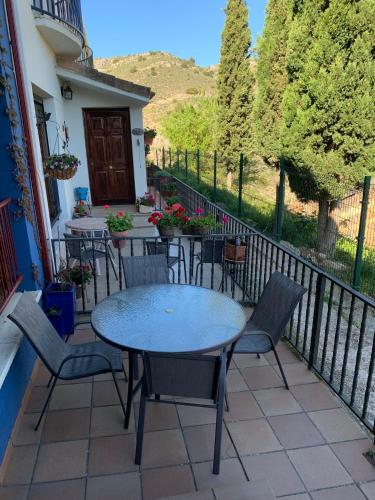 a patio with tables and chairs on a balcony at Mirador Del Río Piedra in Nuévalos