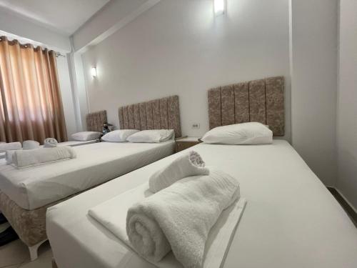 a room with three beds with towels on them at Villa Deart Berat in Berat