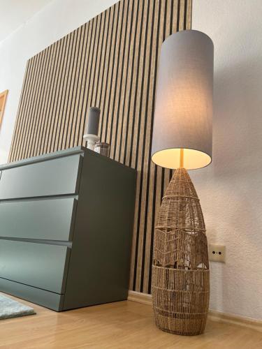 a lamp sitting next to a dresser in a room at City Life Zentrum Zwickau in Zwickau