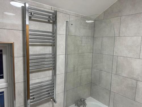 a shower with a glass door in a bathroom at Black Horse Inn Hotel in London