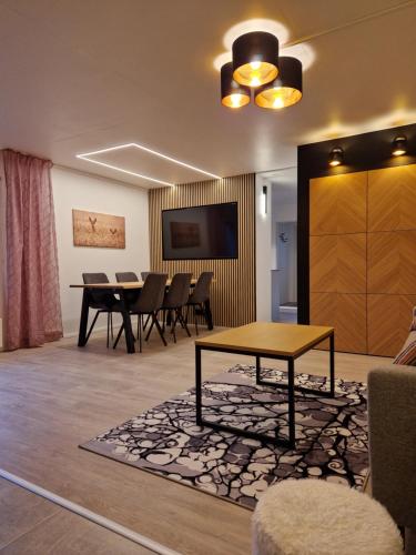 a living room with a table and a dining room at Villa Kataja in Siuntio