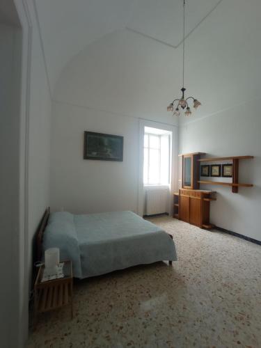a bedroom with a bed and a table and a window at Casa Scottodiuccio in Procida