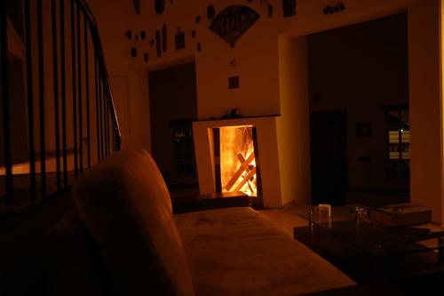 a living room with a fire in the fireplace at Edassery Cokkers tower in Kodaikānāl