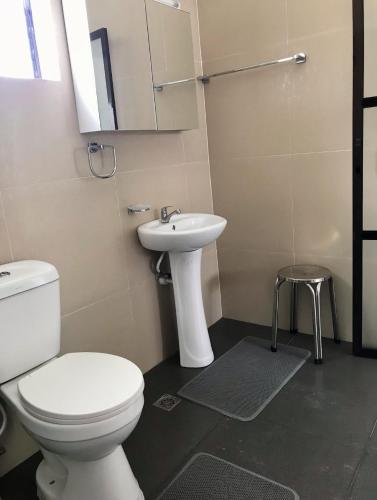 a bathroom with a toilet and a sink at Shrivasta Cottages in Itum