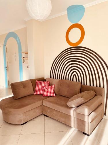 a living room with a brown couch in front of aoked at Family Tree - WATER Available - SELF check in in Golem