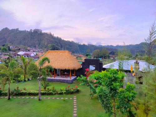 a view of a resort with a grass roof at Lake Batur Cottage 3 in Kubupenlokan