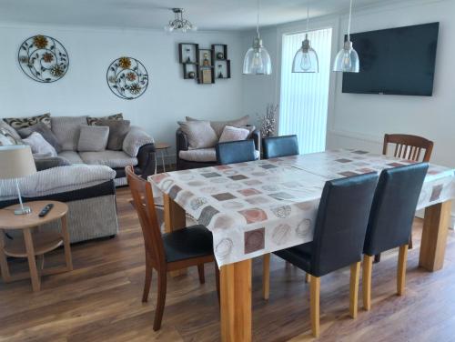 a dining room with a table and chairs at Waterfront Location, Balcony, Sea Views, Free Parking in Pembrokeshire