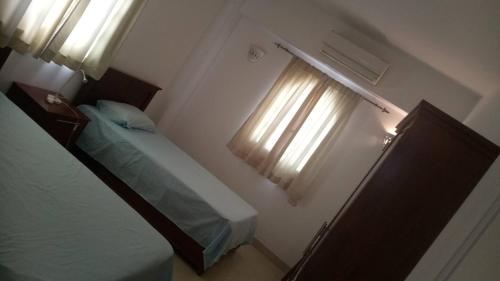 a small bedroom with a bed and a window at Dahab Home - Rahma Luxury Apartment in Dahab