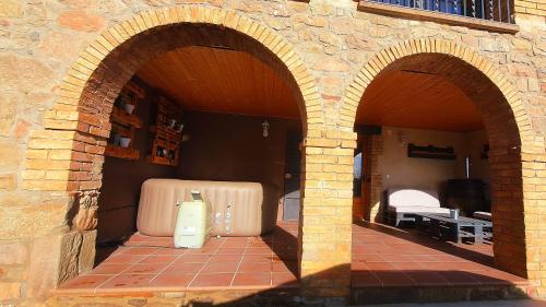 two large suitcases are sitting in an arch way at Cal Ganyada, Casa Rural Cardona in Cardona