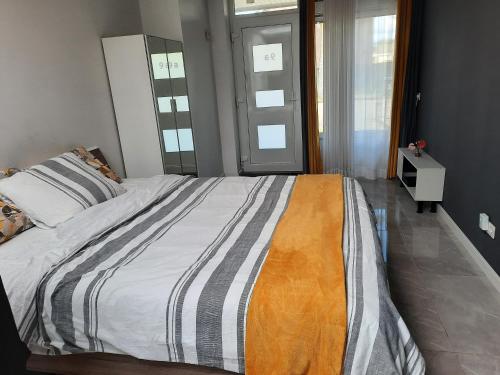 a bedroom with a large bed with a striped blanket at Studio in Eindhoven in Eindhoven