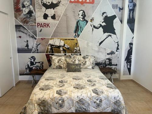 um quarto com uma cama e uma parede com cartazes em Luxury City Centric Bliss in the heart of it all! em Miami