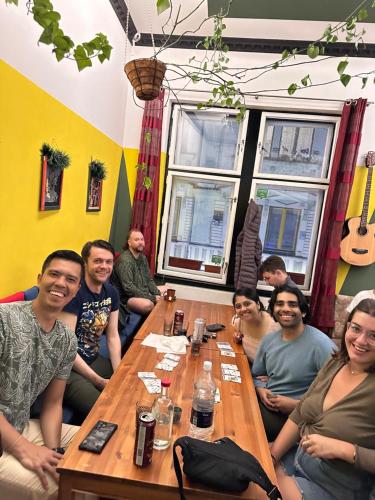 a group of people sitting around a table at Hostel Vagabond in Sarajevo