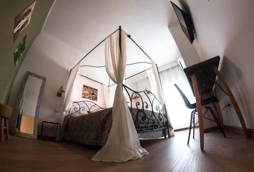 a bedroom with a bed with a canopy at Verrazzano 37 Guest House in Rome