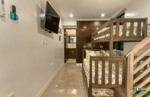 a room with a bunk bed and a staircase at Adora's Place in Coron