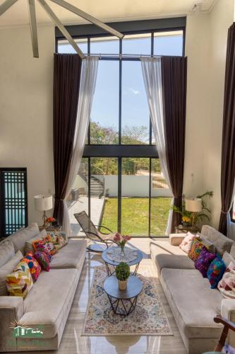 a living room with couches and a large window at Adora's Place in Coron