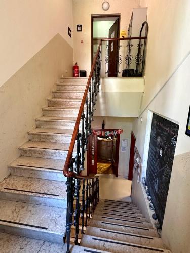 a staircase in a house with wooden railings at Hostel Vagabond in Sarajevo