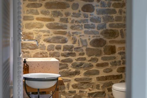 a stone bathroom with a sink and a toilet at Panfilo Farmhouse in Cellino Attanasio