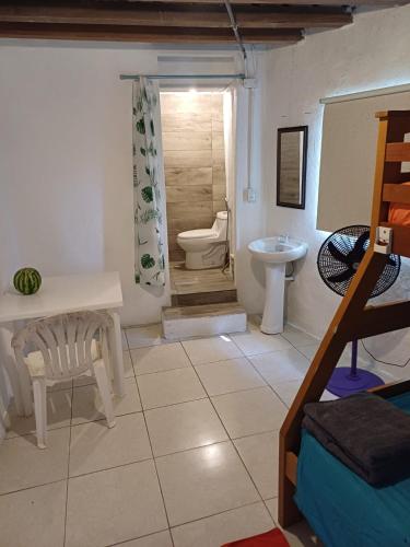 a bathroom with a toilet and a sink at Cabaña La Punta in Isla Grande