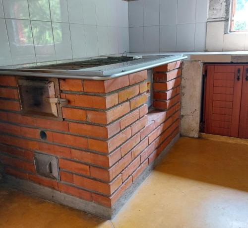 a brick island in a kitchen with a brick wall at Finca La Macarena by Welttisch in Génova