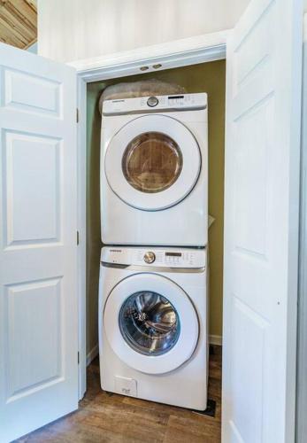 a washer and dryer in a small room at Balk Oasis, Mountain Views,Rustic, HotTub in Stanley