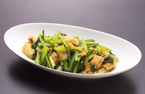 a white bowl of food with green beans and meat at Kumamoto Washington Hotel Plaza in Kumamoto
