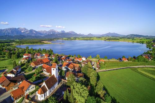 an aerial view of a small town by a lake at Landhotelwohnung in Seeg in Seeg