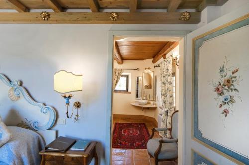 a bedroom with a bed and a desk and a chair at Il Falconiere Relais & Spa in Cortona