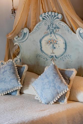 a close up of a bed with pillows on it at Il Falconiere Relais & Spa in Cortona