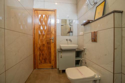 a bathroom with a toilet and a sink at PerfectStayz Value Paradise near Bhatta Falls in Mussoorie