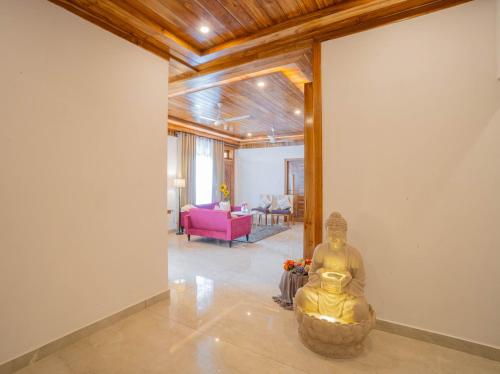a room with a statue in the middle of a room at PerfectStayz Value Paradise near Bhatta Falls in Mussoorie