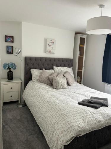 a bedroom with a large bed and a lamp at THE ANCHOR in Hastings