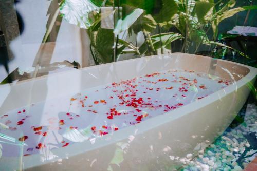 a bowl of confetti on a table with plants at Flowering Villa in Xiaoliuqiu