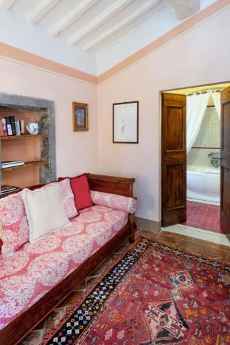 a living room with a couch and a rug at Il Falconiere Relais & Spa in Cortona