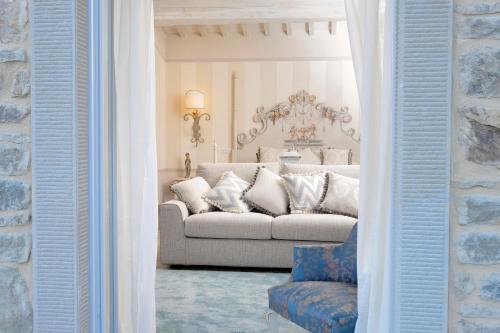 a living room with a couch and a chair at Il Falconiere Relais & Spa in Cortona