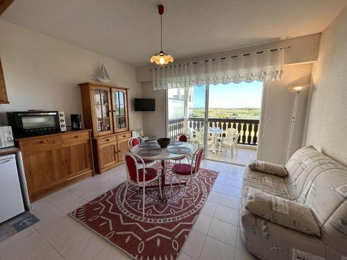 un salon avec une table et un canapé dans l'établissement Appartement 2 pièces avec balcon, proche plage et golf - Saint Jean de Monts - FR-1-224C-285, à Saint-Jean-de-Monts