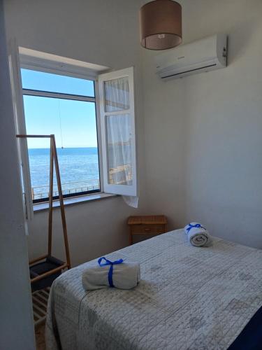 a bedroom with a bed with a view of the ocean at Le due conchiglie in Carini
