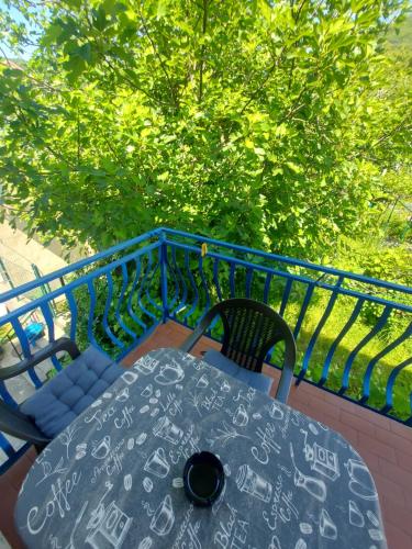a table and chairs sitting on a balcony at Barcelona Apartments in Tivat