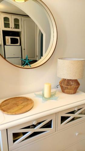 a table with a mirror and a candle on it at Estrella in Mar de Cristal