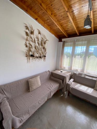 a living room with a couch and a table at Pedi’s house in Aspropótamos