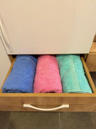 a drawer with different colored towels in it at Qyteza Guest House & Camping in Shkodër