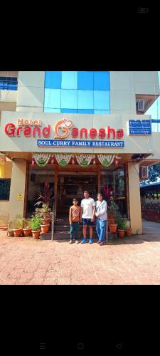a group of three men standing outside of a store at Hotel Grand Ganesha in Ganpatipule