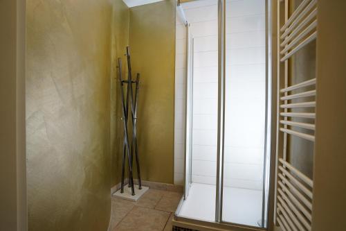 a walk in shower in a bathroom with yellow walls at Villa Seeblick am Strand in Flessenow