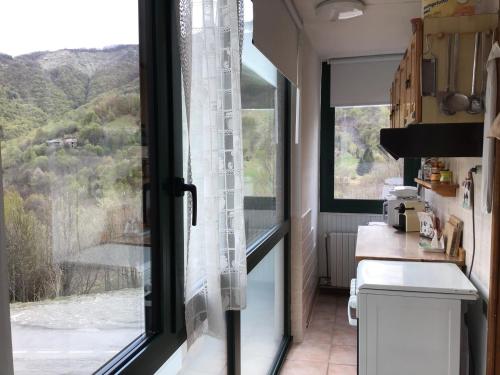 a kitchen with a large window with a view at SCI AI PIEDI in Limone Piemonte