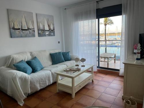 a living room with a white couch and a table at Puerto Deportivo in Punta Umbría