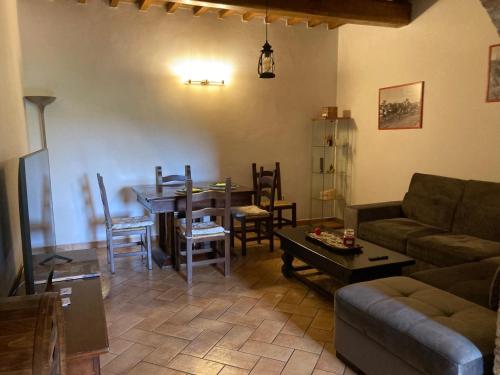 a living room with a couch and a table and chairs at Badia Antica in Lugnano