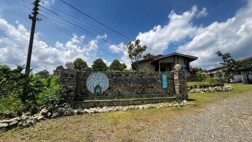 a stone sign in front of a house at 4 Simple Minimalistic Rooms at Sunset Lodge - Eco Valley Retreat 豐之谷 in Balung