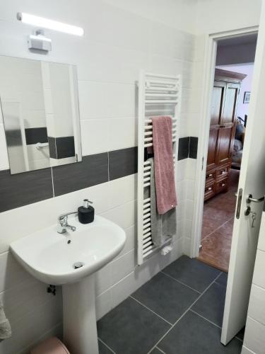 a bathroom with a sink and a mirror at Villa Tranquilla apartment in Oliveira do Hospital