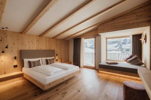a bedroom with two beds and two windows at Rifugio Alpino Pralongià in Corvara in Badia
