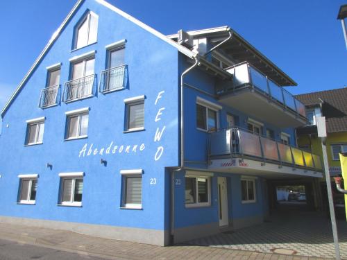 a blue building with a sign on the side of it at Ferienwohnungen Abendsonne - 8 Gehminuten zum EP in Rust