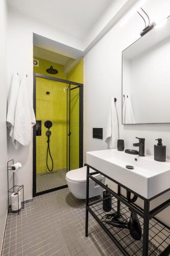a bathroom with a sink and a shower and a toilet at Mariposa Rooms Taksim in Istanbul